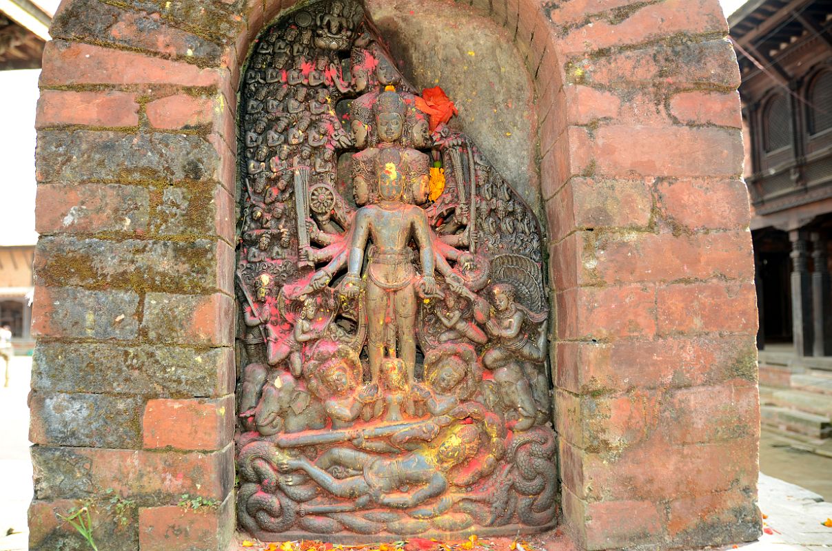 Kathmandu Changu Narayan 10-1 10 Headed And 10-Armed Vishnu Stone Statue With Another Vishnu Below Lying On Serpent Ananta A small black slab from 5C or 6C at Changu Narayan has a 10-headed and 10-armed standing Vishnu, with another Vishnu reclining on the serpent Ananta below. The scenes are divided into three sections � the heavens, the world of men, and the underworld below.